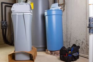 plumber installing a whole-home water softener in a Sahuarita garage